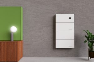 Pure Drive solar battery system paired with a mobile app showing real-time energy data.